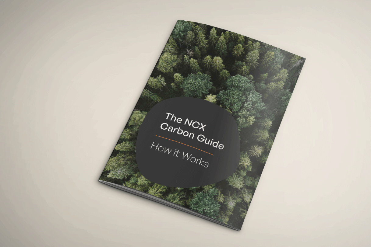 The booklet cover of the NCX carbon guide showing an aerial photo of a green forest