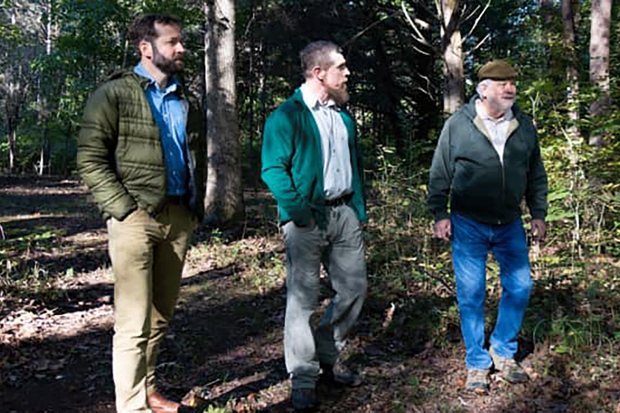 NCX CEO Zack Parisa walks with landowner John Ross and forester Jon Lindsay in Savannah, Tennessee