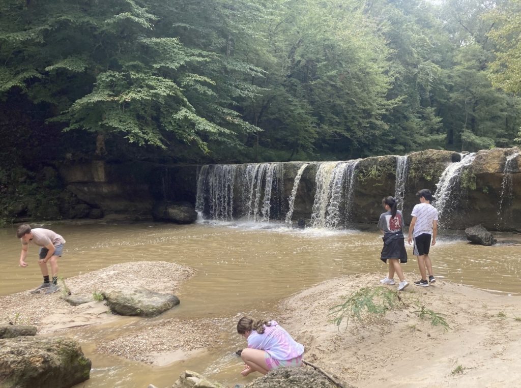 grandchildren playing in the creek